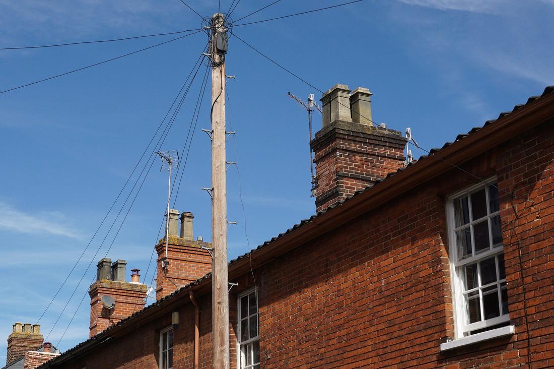 Brick terrace with chimney stacks seen from below